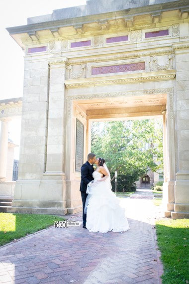 Bride and Groom Share a Kiss Outside Under Arch - Oberlin, Ohio Wedding