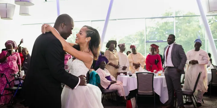 Wedding guests watching the newlyweds during their first dance