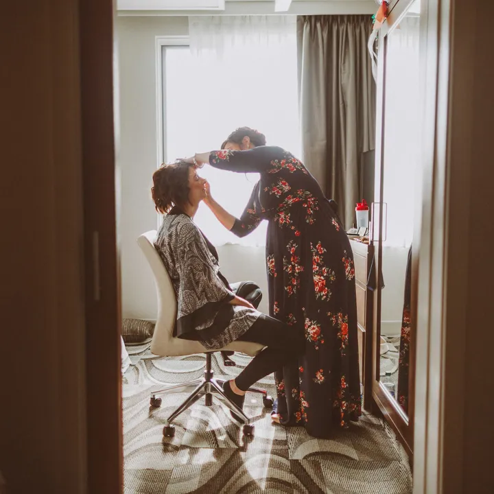 A bride getting her makeup done for her wedding day