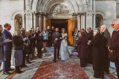 Bride and Groom Walking Out of Church in Snow at Beautiful Ohio Wedding