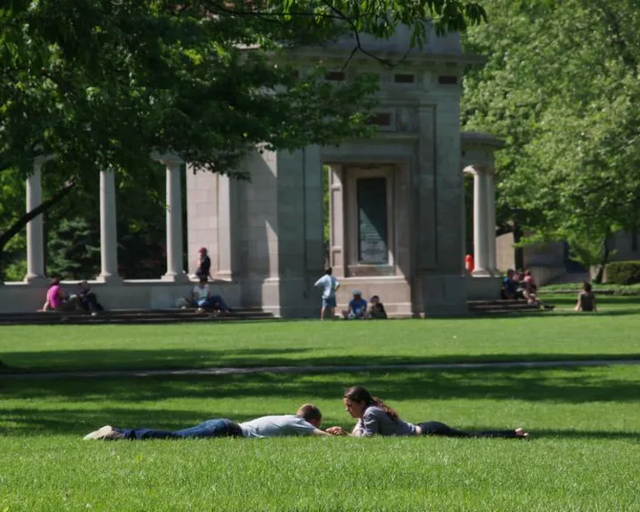 Students lying on the grass outside the Memorial Arch at Oberlin College