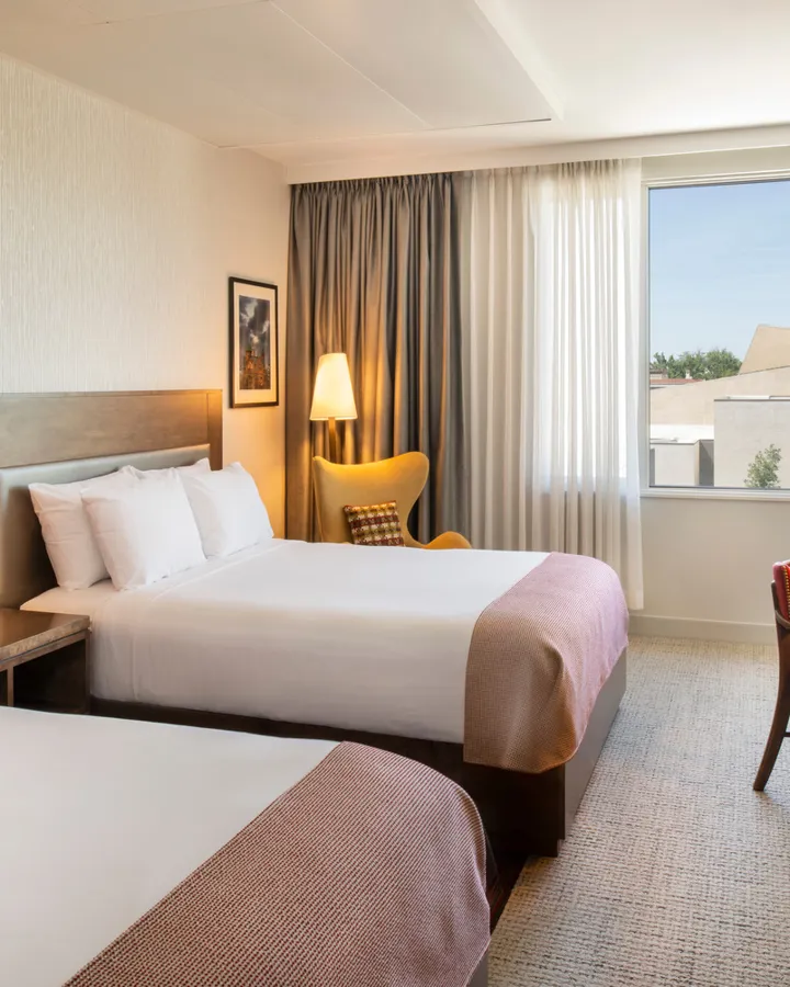 Double queen guest room with a work desk